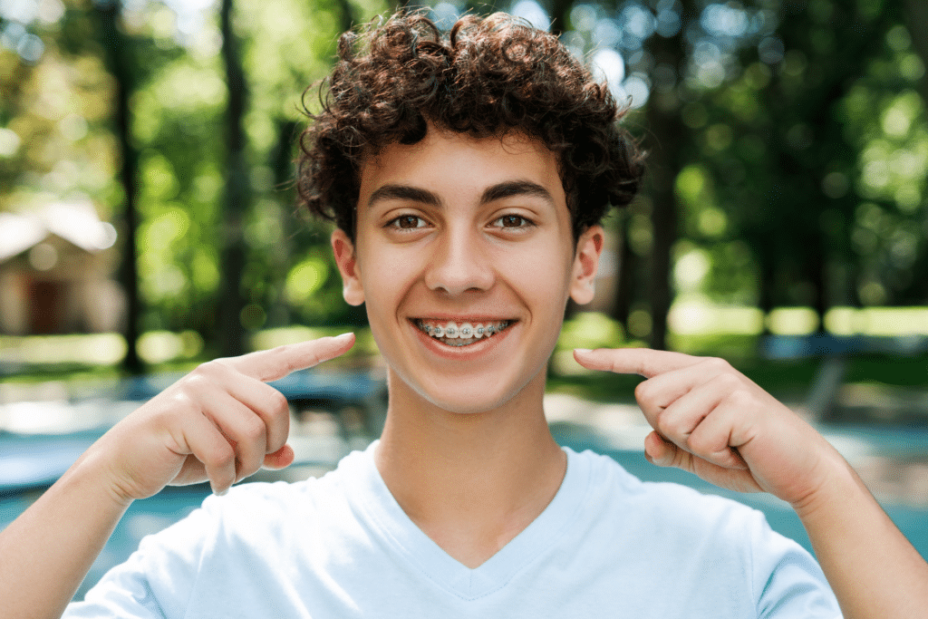 Teen smiling with braces during summer activities in Lake Orion, MI