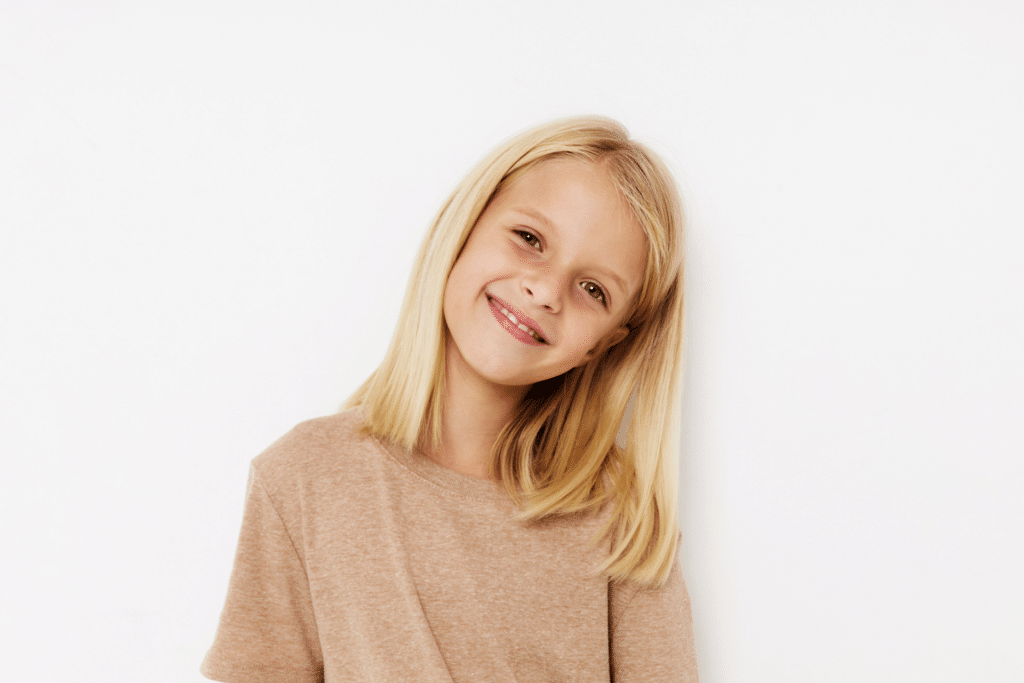Young child smiling before an early orthodontic evaluation in Lake Orion MI