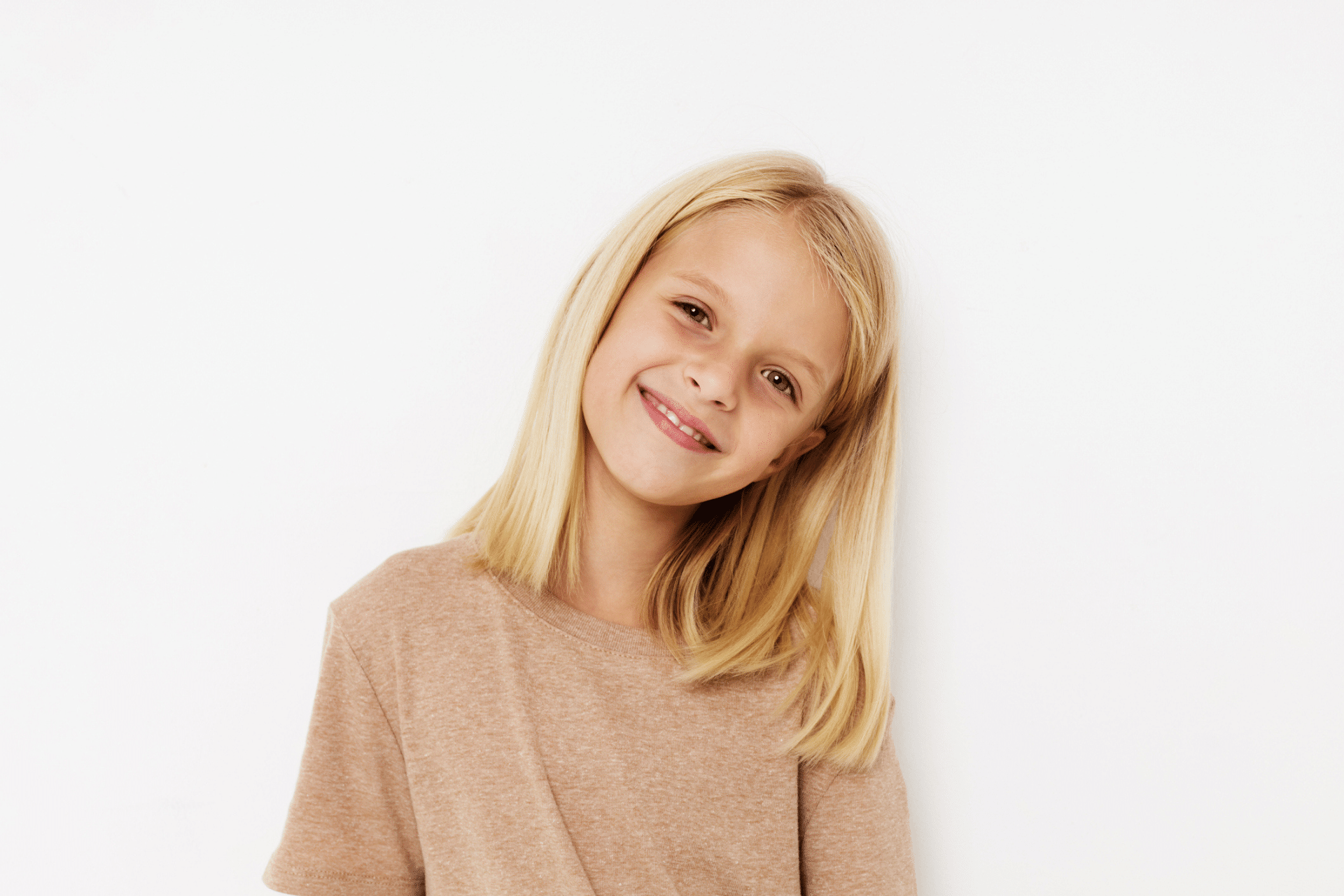 Young child smiling before an early orthodontic evaluation in Lake Orion MI
